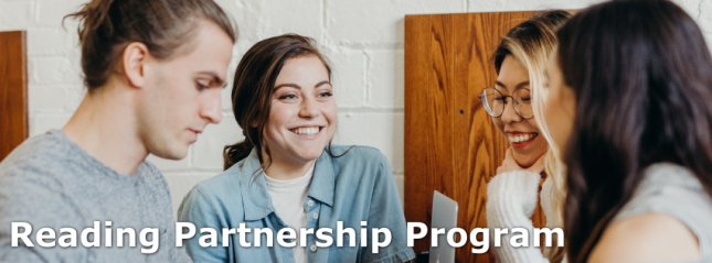 four students are huddled together and talking, on the bottom of the picture there is text that reads 'reading partnership program'