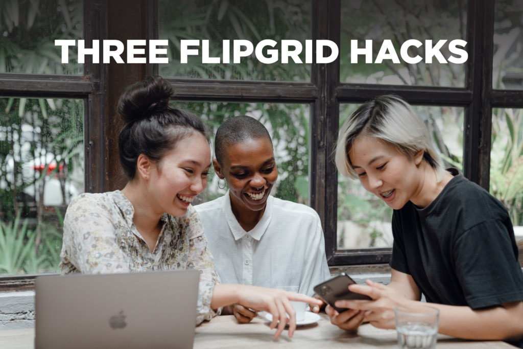 Three girls playing with a smartphone